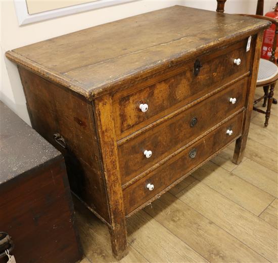 An early 19th century Continental scrumballed pine monks chest, with candle box and base drawer, W.110cm